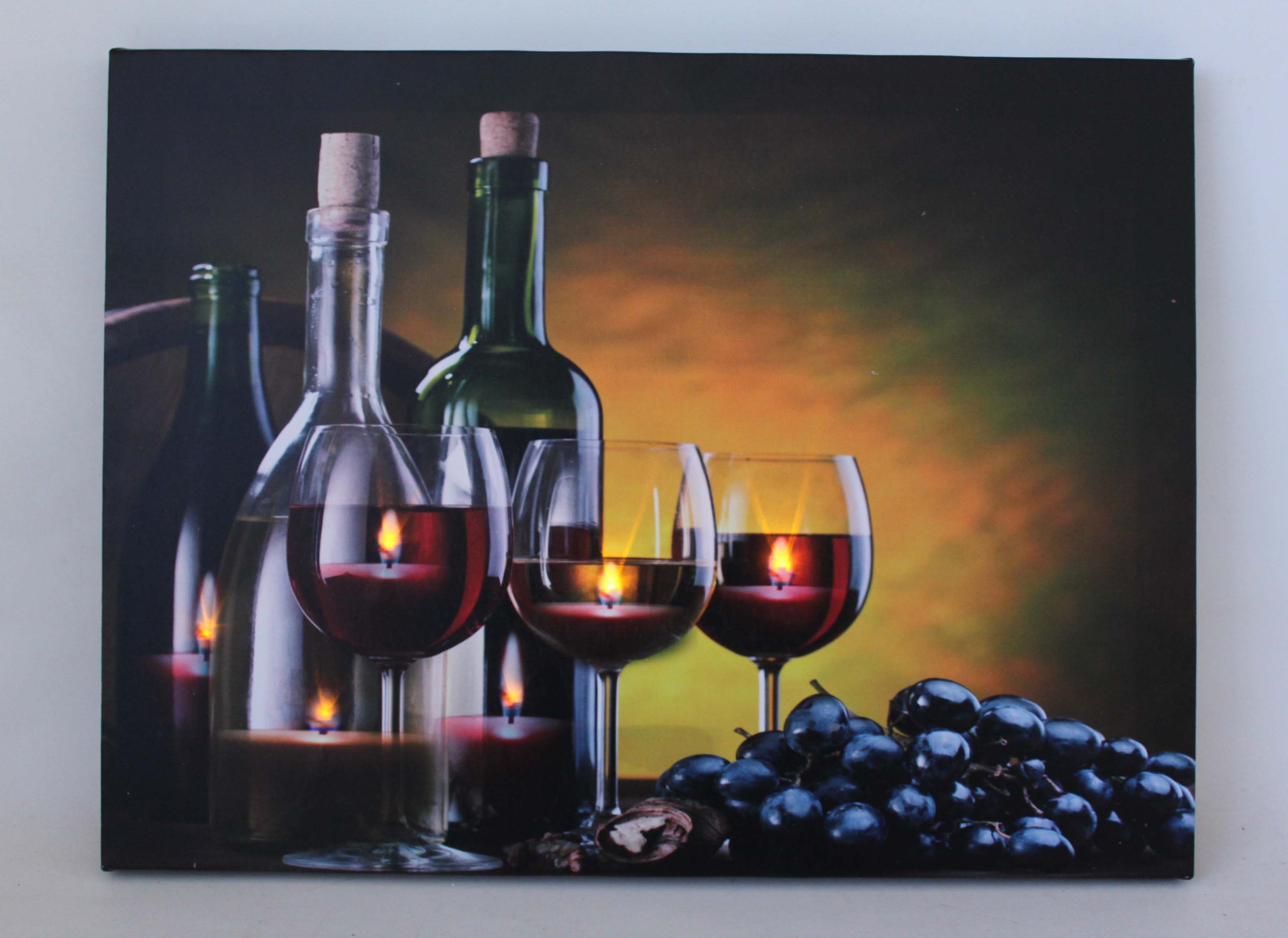 Wine bottles, red wine glasses, candles, and grapes arranged in a still life against a warm gradient backdrop. Wine bottles, red wine glasses, candles, and grapes arranged in a still life against a warm gradient backdrop.