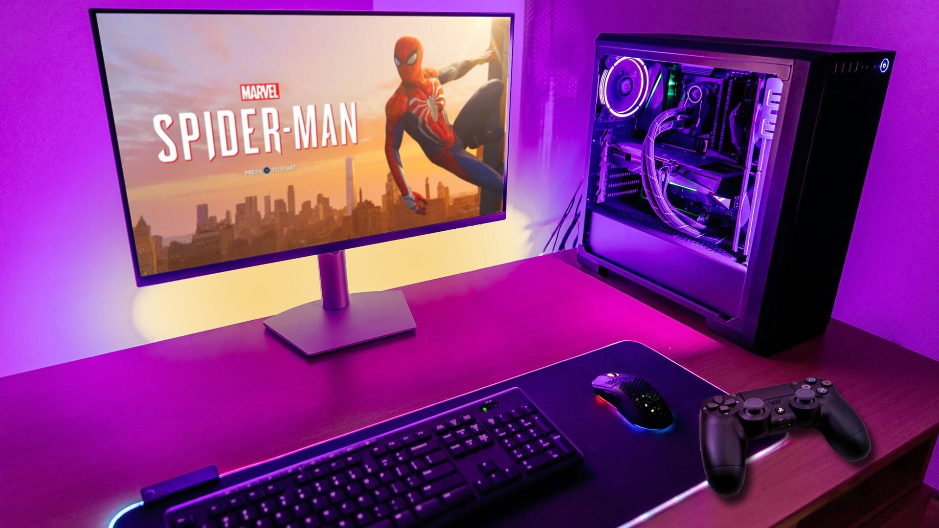 Gaming setup features monitor showing Marvel Spider-Man, PC tower, keyboard, mouse, and controller on desk under purple lighting. Gaming setup features monitor showing Marvel Spider-Man, PC tower, keyboard, mouse, and controller on desk under purple lighting.