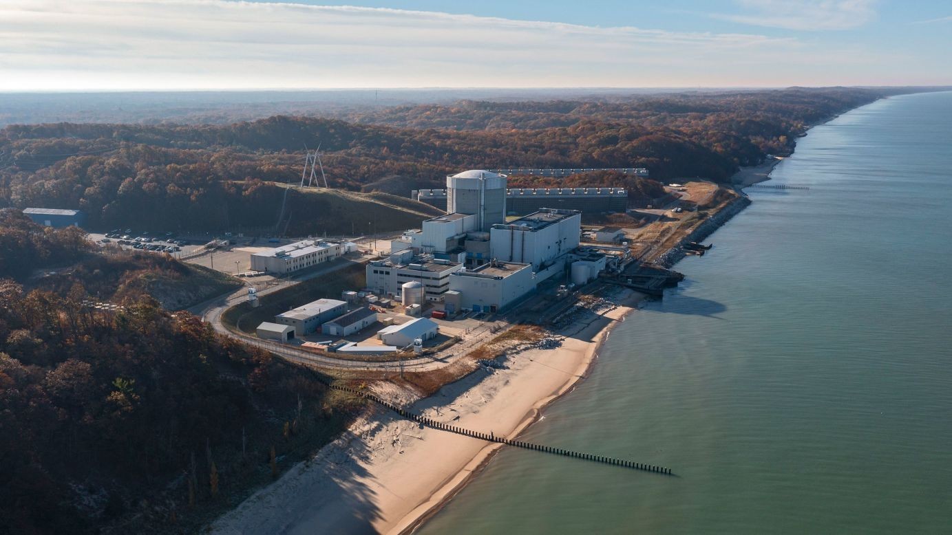 Nuclear power plant complex situated on a sandy beach adjacent to a large body of water. Nuclear power plant complex situated on a sandy beach adjacent to a large body of water.