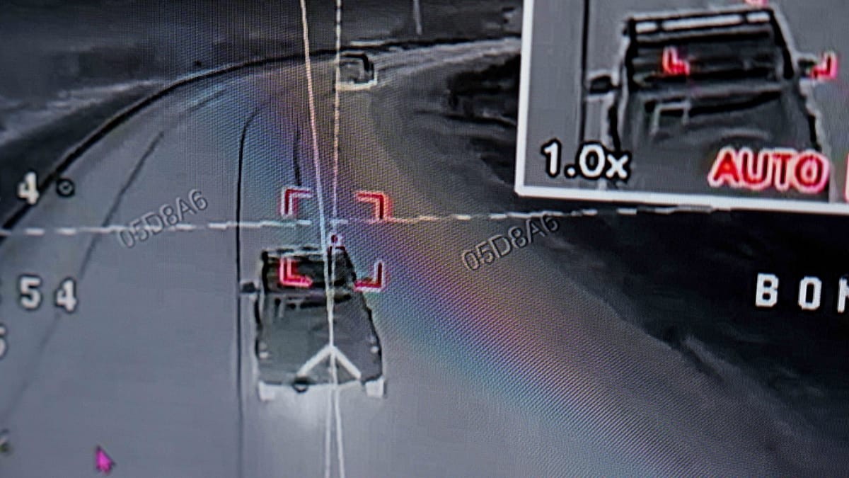 A car travels on a curved road with "AUTO" and vehicle ID labels visible. A car travels on a curved road with "AUTO" and vehicle ID labels visible.